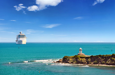 Luxury Cruise ship sailing to port on sunny day