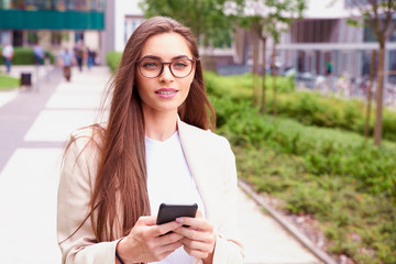 Young businesswoman give a call while walking on the street