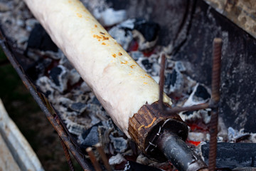 Preparation of CHOCHOCA - tpical food of Chiloe island, Chile. Chiilotan potato bread prepared on wooden stick