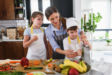 Mother Teaching Kids to Cook and Help in the Kitchen. Healthy Food. Eat Healthier.