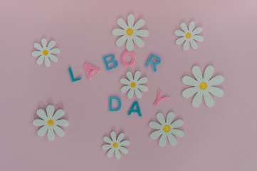 The inscription labor Day on a beautiful pink background. Holiday weekend in September