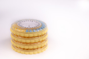 Packaging of hormonal pills on white background