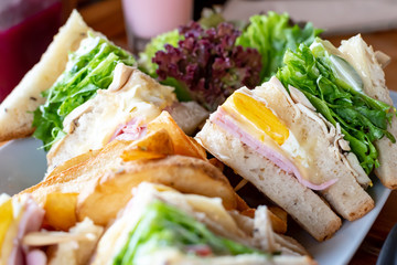 Club whole wheat sandwich with ham and organic vegetable and eggs.Healthy Breakfast.