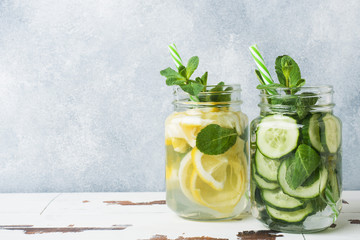 Detox water for healthy lifestyle. Fresh water in jar with lemon, cucumber and mint on wooden table. Copy space