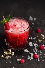 berry cocktail for a bar in the summer with ice and raspberry syrup is very tasty and beautiful