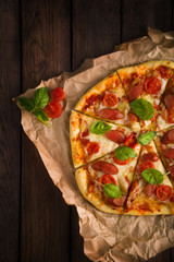 pizza with ham, basilica, tomatoes cherry and cheese