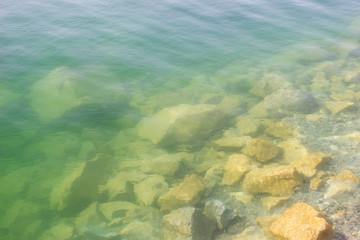 Texture of water surface sun water stones waves - underwater world