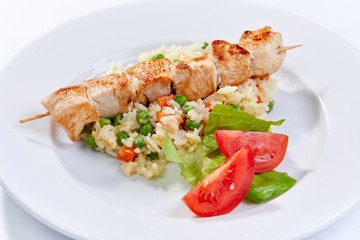 Fototapeta na wymiar chicken kebab with rice and vegetables