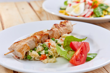 chicken kebab with rice and vegetables