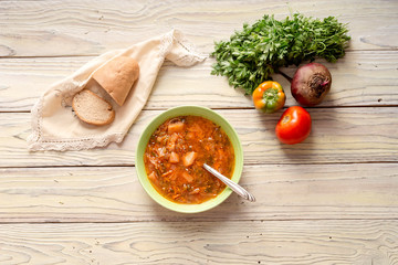 Borscht in a bowl on a wooden table