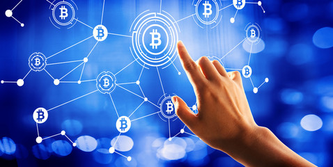 Bitcoin theme with hand pressing a button on a technology screen