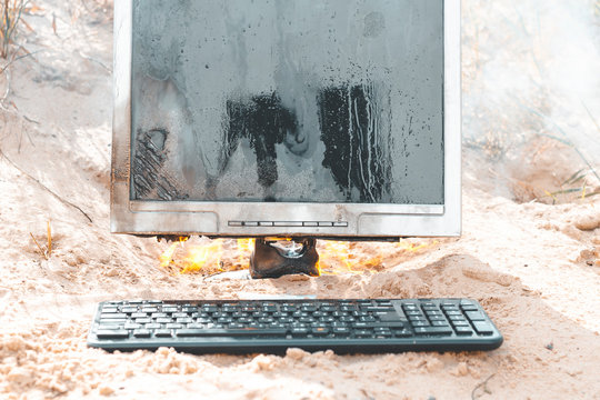 beach sand. bright sun. the monitor burns with smoke. have a keyboard.