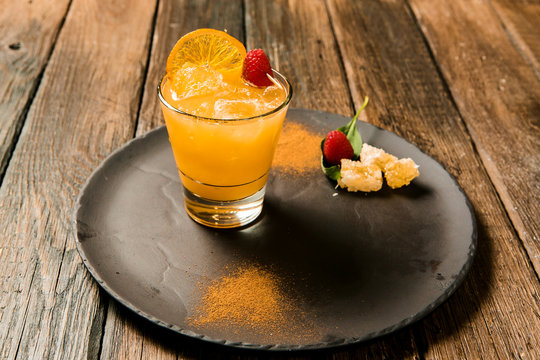 Lemonade or juice. Alcohol drink or cocktail. Images for bar or restaurant menu. Orange drink served with strawberry.