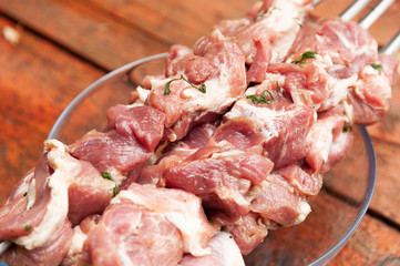 Meat on skewers closeup cooking barbecue.