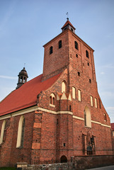 Fototapeta na wymiar The facade of the gothic medieval Catholic Church with belfry of in Grudziadz.