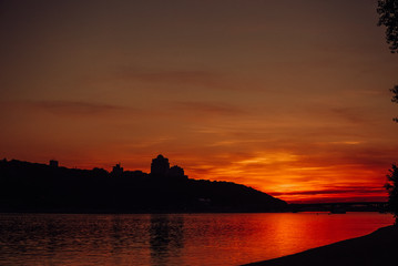 sunset red city river water sky
