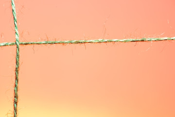 Cross-stranded rope on red and orange background