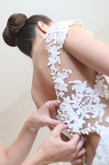 Obraz na płótnie Canvas bridesmaid zips up dress back bride