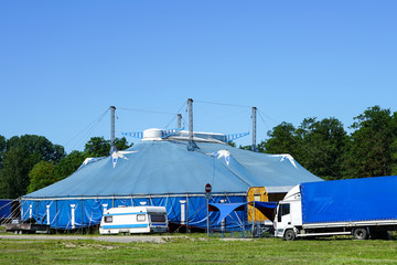 traveling circus blue tent against a blue sky