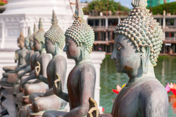 Famous sitting Buddha statues and stupa in the Seema Malaka Temple in Colombo, Sri Lanka. This is situated on Beira Lake and is part of the Gangaramaya Buddhist Temple Complex.