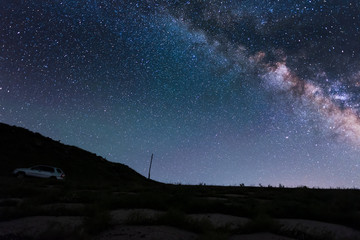 Beautiful night landscape. Starry night  and bright milky way galaxy over the hills.
