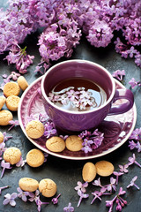 Still life with  lilac flowers and tea with cookies