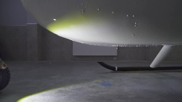 towing the white helicopter out of the hangar