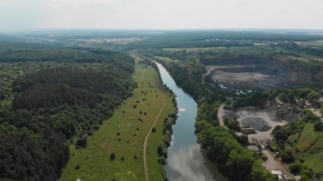 Drone Fast Flying Over River and Near Granite Quarry in Temperate Climate Zone. Europe, Ukraine, Vinnytsia. Aerial. Pivdenny Buh.