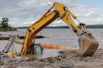Excavator(construction equipment) drowned on the lake while working to strengthen the shore. Safety...