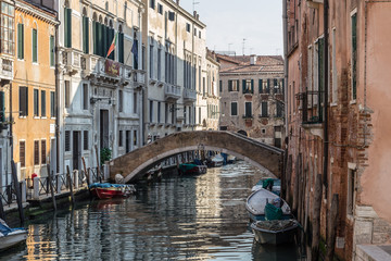 Fototapeta na wymiar VENICE, ITALY - JAN 1, 2016: Water Canal of Venice, Italy. Narrow Streets of Venice. Water transportation, gondola, boats. Architecture buildings of Italy.