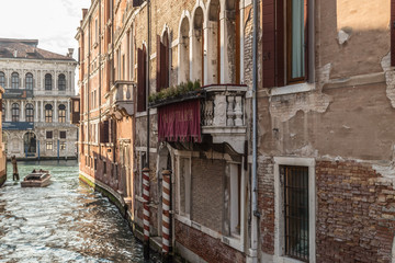 VENICE, ITALY - JAN 1, 2016: Water Canal of Venice, Italy. Narrow Streets of Venice. Water transportation, gondola, boats. Architecture buildings of Italy.