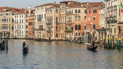 Fototapeta na wymiar VENICE, ITALY - JAN 1, 2016: Water Canal of Venice, Italy. Narrow Streets of Venice. Water transportation, gondola, boats. Architecture buildings of Italy.