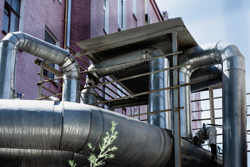 Ventilation pipes on the wall of the building outside the old Industrial building of the factory