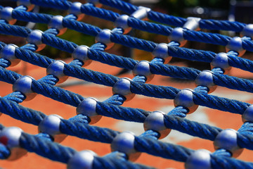 Bright blue rope mesh closeup, playground for play and sport