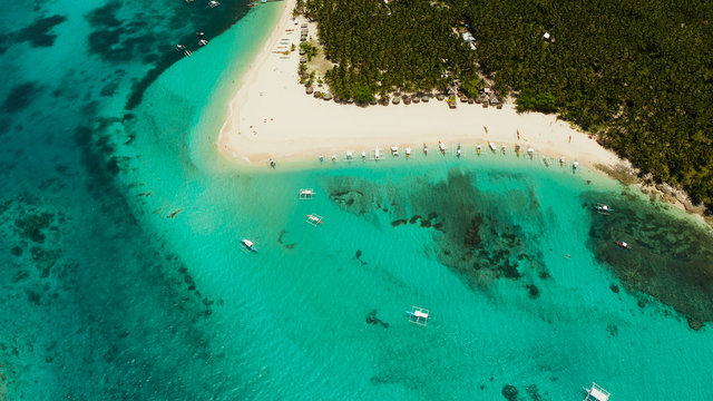 Tropical landscape: Daco island with beautiful beach, palm trees by turquoise water view from above. Siargao, Philippines. Summer and travel vacation concept