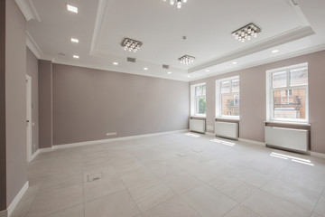 panoramic view office corridor with rooms for receiving guests unfurnished with wide windows and tiled floors, the interior is in gray tones