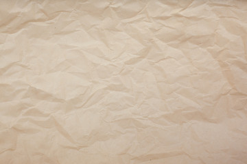 Fototapeta premium Pale brown crumpled paper texture background. Abstract pattern