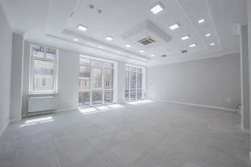 open-air office without furniture for negotiating with customers, made in gray tones with large panoramic windows and tiles.