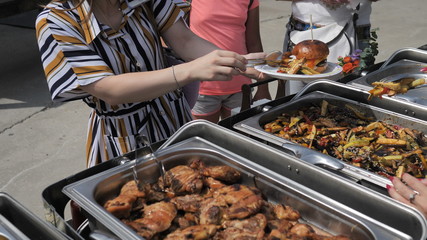 Assorted Natural and Organic Meat Corn Vegetables Burger cooked on the Grill are served to guests.