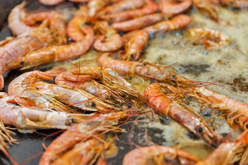 cooking shrimps in boiling oil closeup