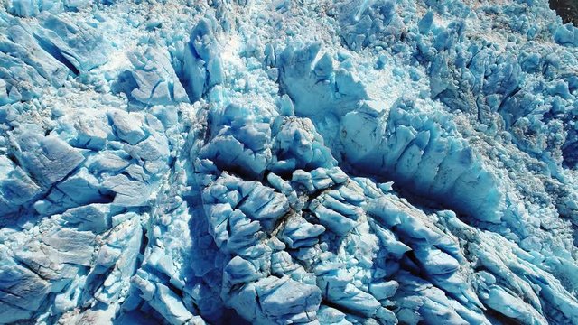 Aerial reveal from glacier over the sea and ice