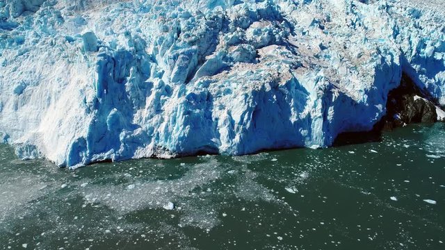 Aerial of glacier ending in the sea water. coast