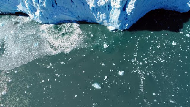 View from above of glacier iceberg melting into the sea