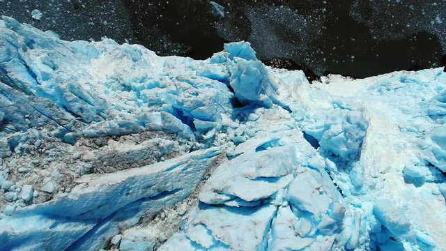 View from above of glacier ending in the sea