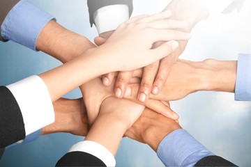 Handshake of many young business people, teamwork concept