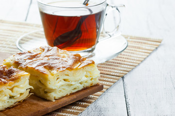 Turkish su boregi, burek or borek, turkish water patty slices with cheese and turkish tea,...