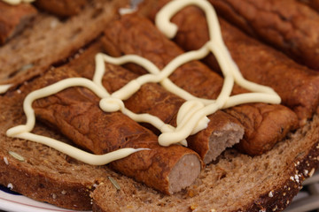 frikandel on bread with mayonnaise, a traditional Dutch snack, a sort of minced meat hot dog