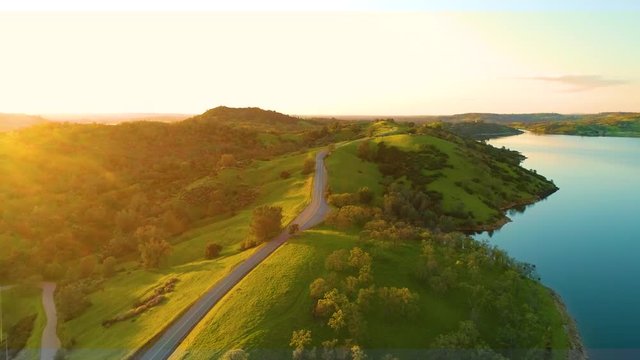 Aerial View  Dam Village waterfront  4K Helicopter Shot  landmark trees road cars cloudes california lake
