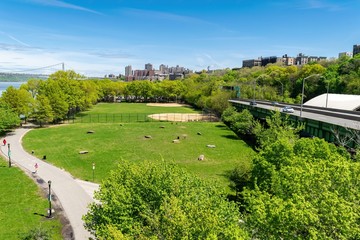 Arial view across Riverbank State Park in New York City, with Upper Manhattan and the George Washington Bridge in the background