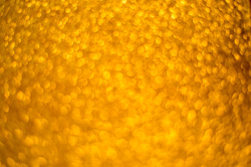 Gold glitter christmas abstract background. Defocused sequin light.